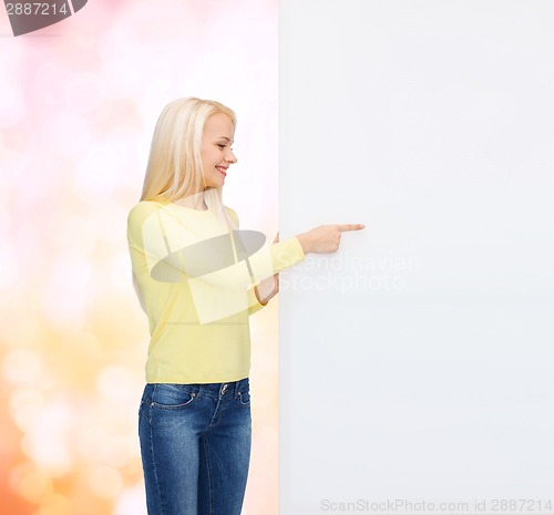 Image of smiling woman in sweater with blank white board