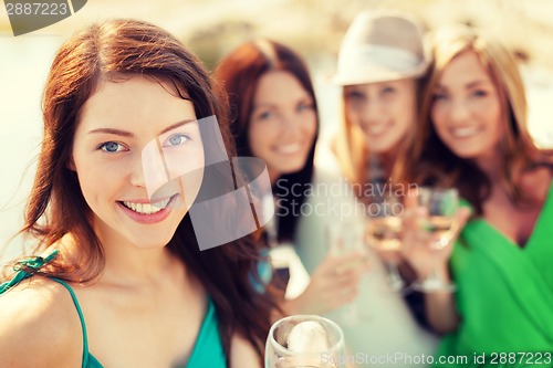Image of smiling girls with champagne glasses