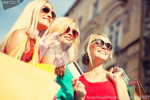 Image of beautiful women with shopping bags in the ctiy