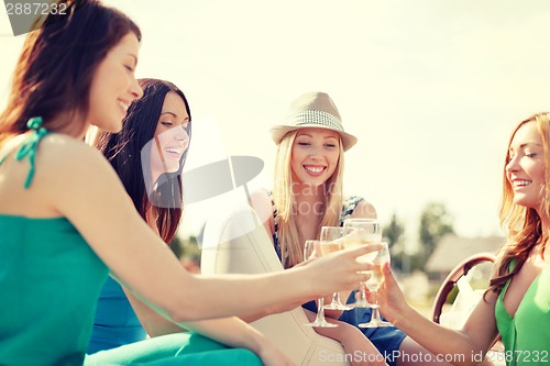 Image of smiling girls with champagne glasses