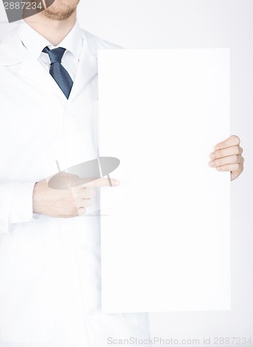 Image of doctor holding blank white banner