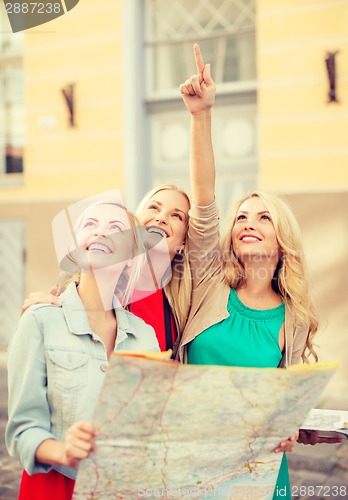 Image of beautiful blonde women with map in the city