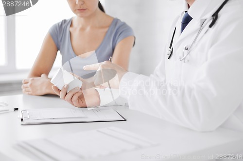 Image of patient and doctor prescribing medication