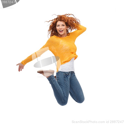 Image of smiling young woman jumping in air