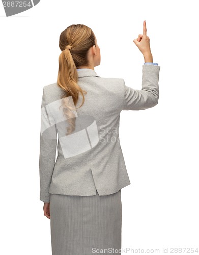 Image of businesswoman or teacher in suit from back
