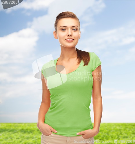 Image of smiling young woman in blank green t-shirt