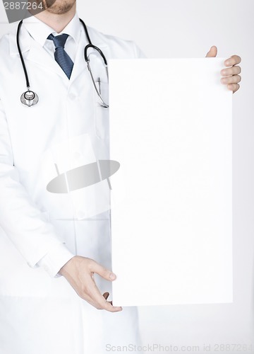 Image of doctor holding blank white banner