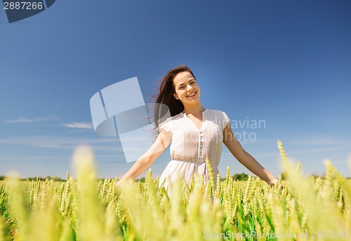 Image of smiling young woman on cereal field
