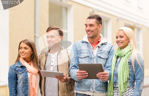 Image of group of smiling friends with tablet pc computers