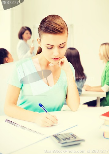 Image of student girl with notebook and calculator