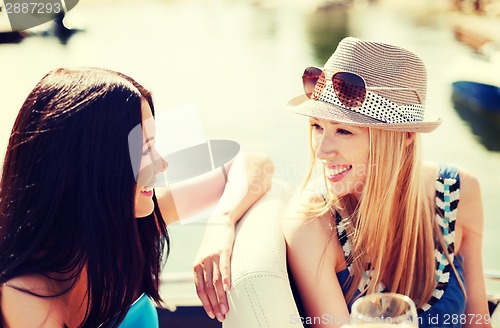 Image of girls with champagne glasses on boat