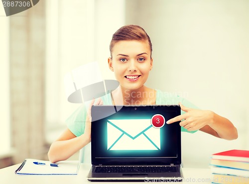 Image of smiling student girl with laptop at school