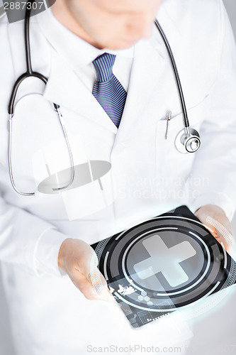 Image of male doctor holding tablet pc with medical app