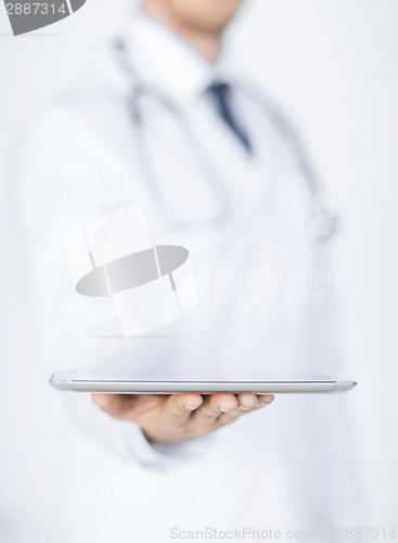 Image of male doctor holding tablet pc