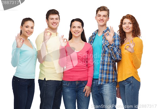 Image of group of smiling teenagers showing ok sign
