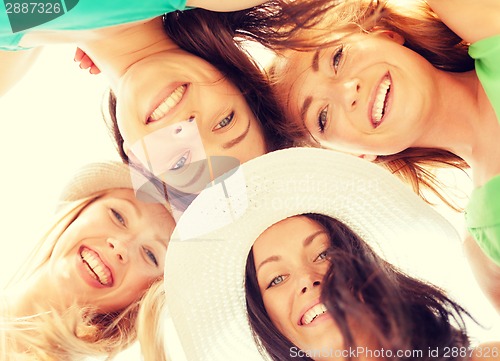 Image of faces of girls looking down and smiling