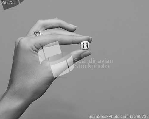 Image of woman holding dice