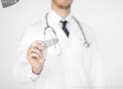 Image of doctor writing something in the air