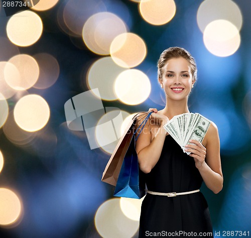 Image of smiling woman in dress with shopping bags