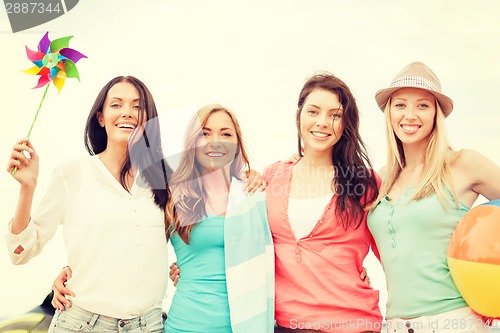 Image of smiling girls having fun on the beach