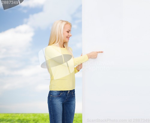 Image of smiling woman in sweater with blank white board