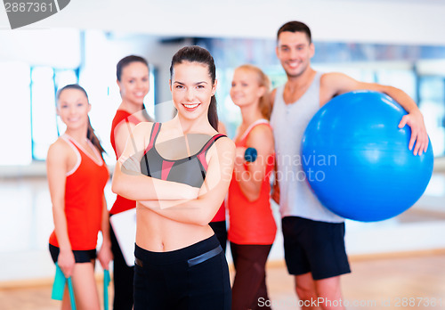 Image of woman standing in front of the group in gym