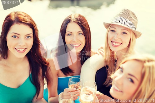 Image of smiling girls with champagne glasses