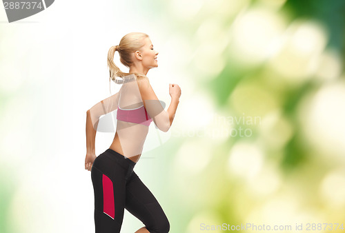 Image of sporty woman running or jumping