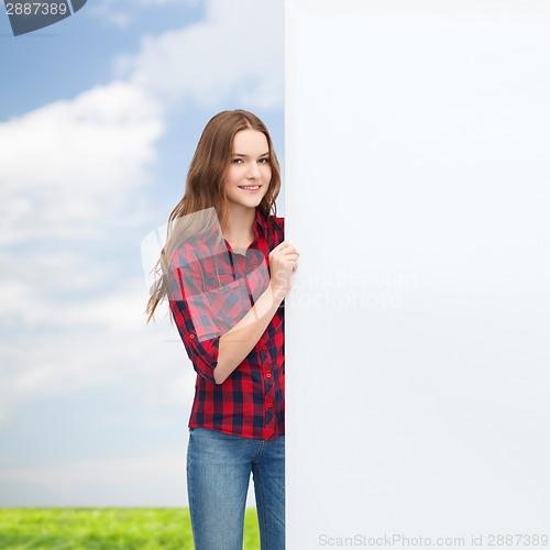 Image of smiling young teenage girl with white blank board