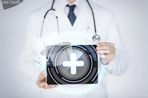 Image of male doctor holding tablet pc with medical app