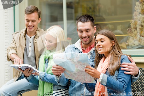 Image of group of friends with guide and map exploring town