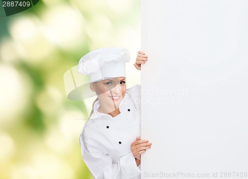 Image of smiling female chef with white blank board