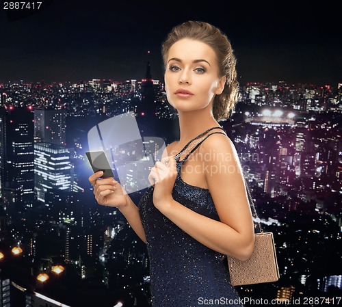 Image of woman in evening dress with vip card