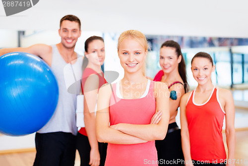 Image of woman standing in front of the group in gym