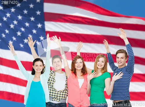 Image of group of smiling students waving hands