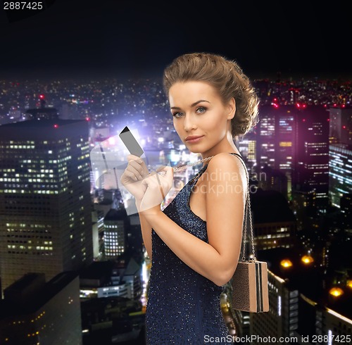 Image of woman in evening dress with vip card