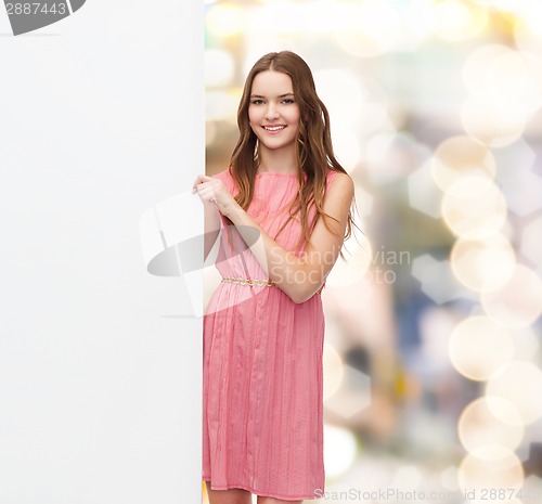 Image of young woman in dress with white blank board