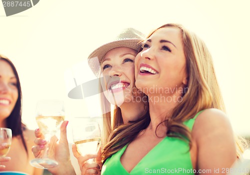 Image of girls with champagne glasses on boat