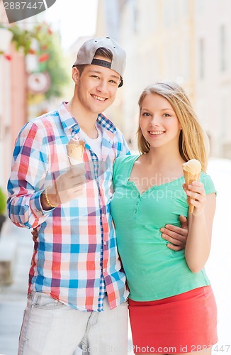 Image of smiling couple with ice-cream in city