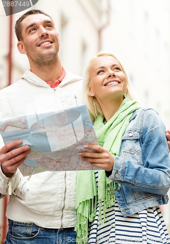 Image of happy couple with map exploring city