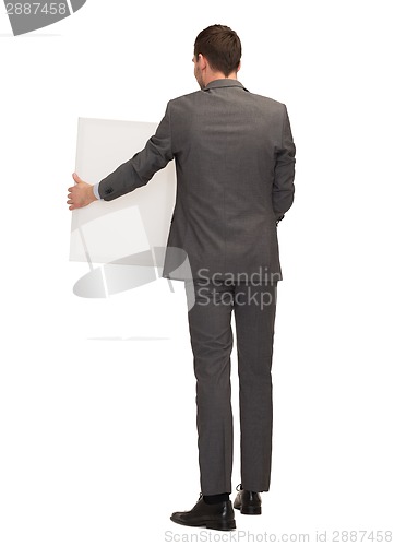 Image of businessman or teacher with white board from back