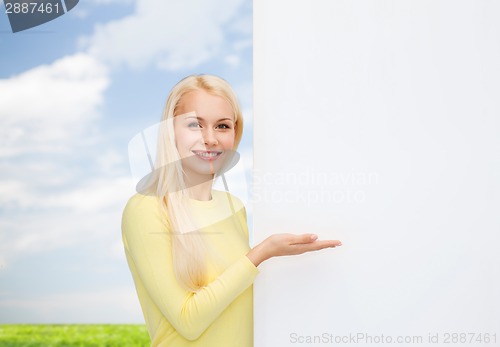 Image of smiling woman in sweater with blank white board