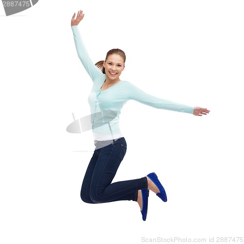 Image of smiling young woman jumping in air