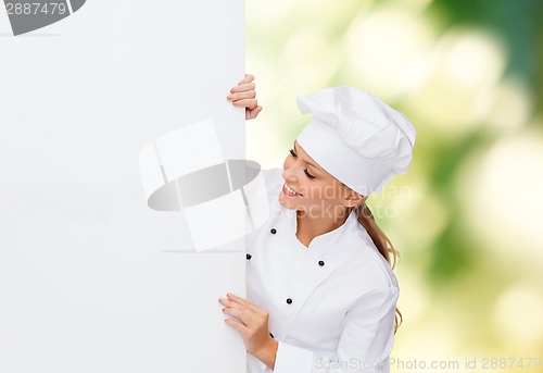 Image of smiling female chef with white blank board