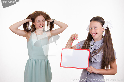 Image of Trainee with a sign mocks pupil