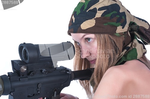 Image of Beautiful young woman aims on sniper rifle