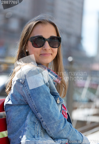 Image of Young beautiful stylish girl smiling on a sunny day