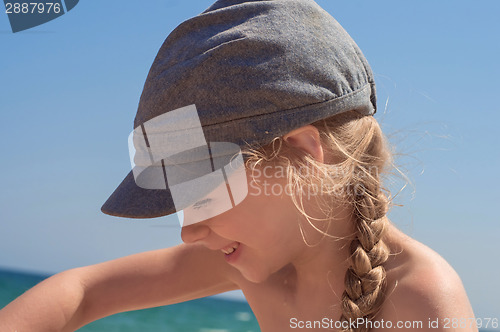 Image of Adorable little girl in denim cap