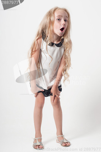 Image of Little girl in white dress fooling around