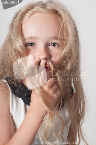 Image of Little girl with long hair fooling around